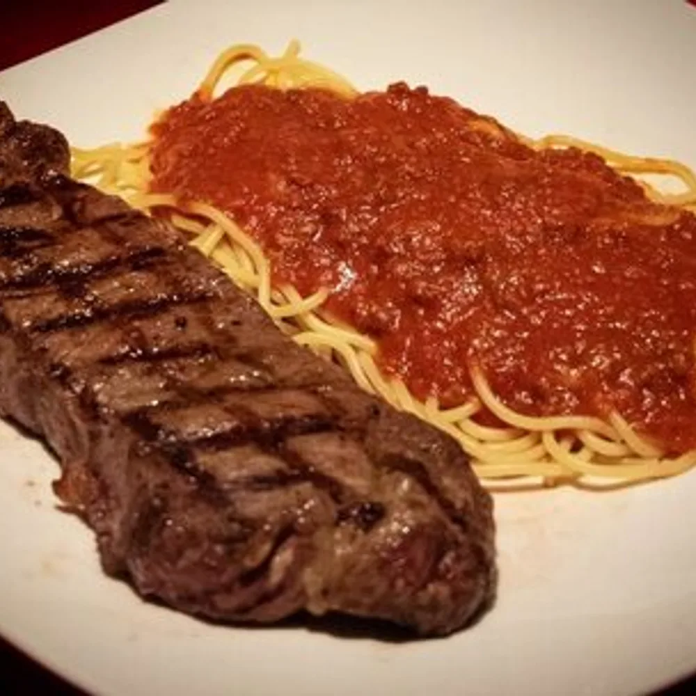 Grilled New York steak with pasta and marinara